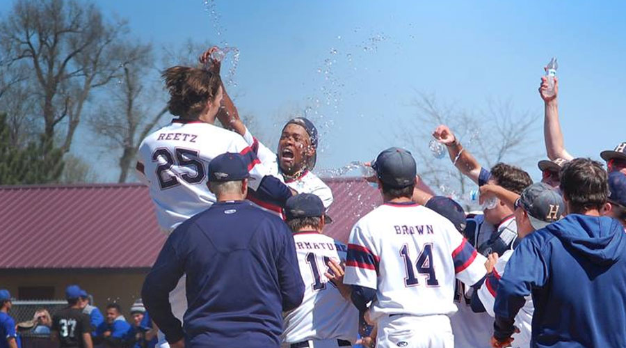 Will Reetz is congratulated by teammates after a walk-off three-run home run in the bottom of the eighth on Sunday in Hutchinson's 6-3, eight-inning win over Pratt. (Casey Bailey/Blue Dragon Sports Information)