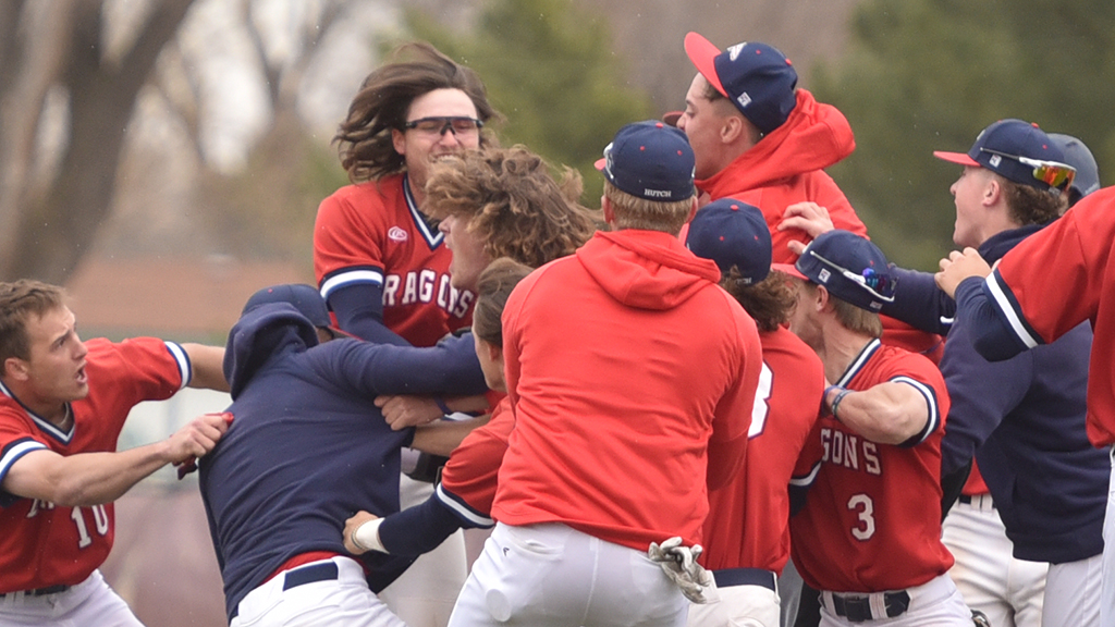 Blue Dragon teammates swarm Ben McLaughlin after he delivers a walkoff RBI single in the bottom of the seventh of Game 1 of Friday's KJCCC doubleheader vs. Seward County at Hobart-Detter Field. (Sammi Carpenter/Blue Dragon Sports Information)