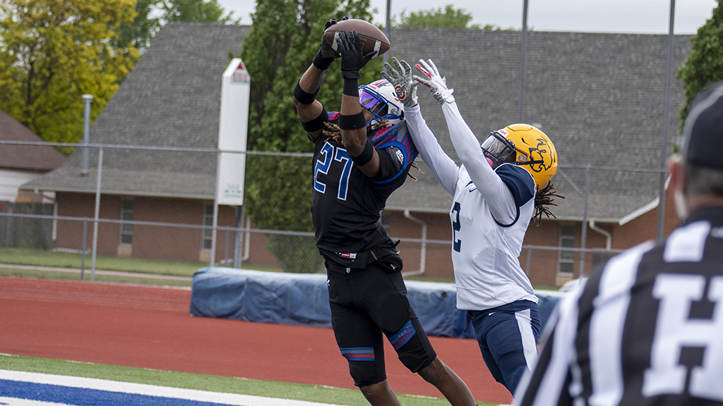 Marquise Gilbert intercepts a Highland pass and returns it a school-record 100 yards for a touchdown in No. 1 Hutchinson's 77-7 over Highland on Sunday at Hobart-Detter Field. (Andrew Carpenter/Blue Dragon Sports Information)