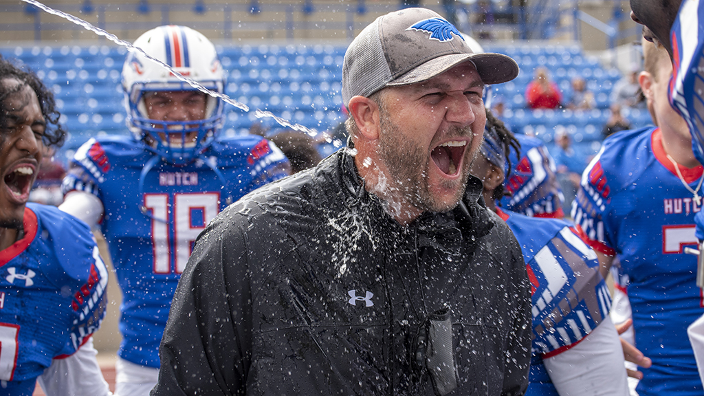 Blue Dragon head coach Drew Dallas is doused with water in the final seconds of No. 1 Hutchinson's 70-14 Jayhawk Conference championship-clinching victory over Dodge City on Sunday at Gowans Stadium. (Andrew Carpenter/Blue Dragon Sports Information)
