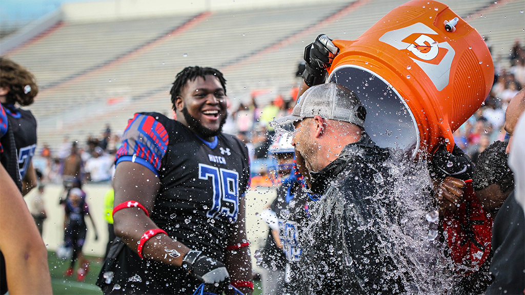 Blue Dragon head coach Drew Dallas gets doused with water to start a championship celebration as the No. 1-ranked Blue Dragons defeat No. 2 Snow College 29-27 to win the 2020-21 NJCAA Football Championship on Saturday in Little Rock, AR. (Photo courtesy Billy Watson/The Hutchinson News)