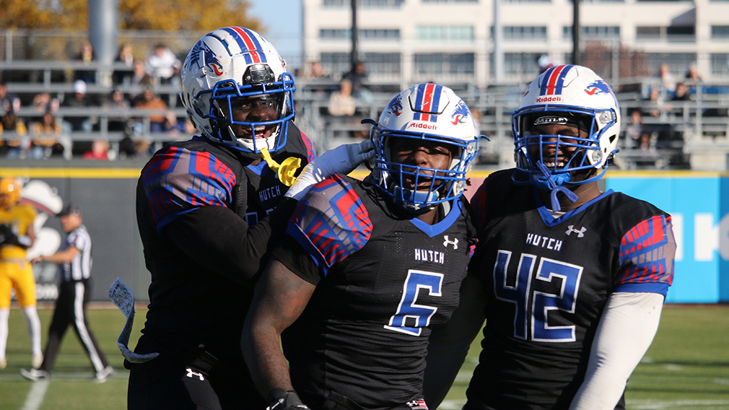 Davion Westmoreland (6) is congratulated by teammates after a third-quarter interception, one of four in the game by the Blue Dragons, in No. 8 Hutchinson's 49-19 victory over No. 11 Garden City to capture the 2021 KJCCC Playoff Championship. (Cassidy Smith/Blue Dragon Sports Information)
