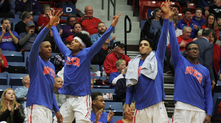 The Blue Dragon bench celebrates one of Hutch's 12 3-pointers in a 95-76 victory over Colby on Saturday at the Sports Arena. (Bre Rogers/Blue Dragon Sports Information)