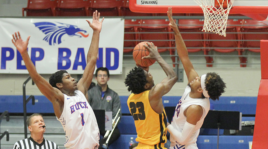 D.J. Mitchell (right) and Saquan Singleton (left)  go high to defend a Cloud County shot in the second half of the No. 6-Blue Dragons 90-75 Jayhawk Conference victory over Cloud County on Wednesday at the Sports Arena. (Bre Rogers/Blue Dragon Sports Information)