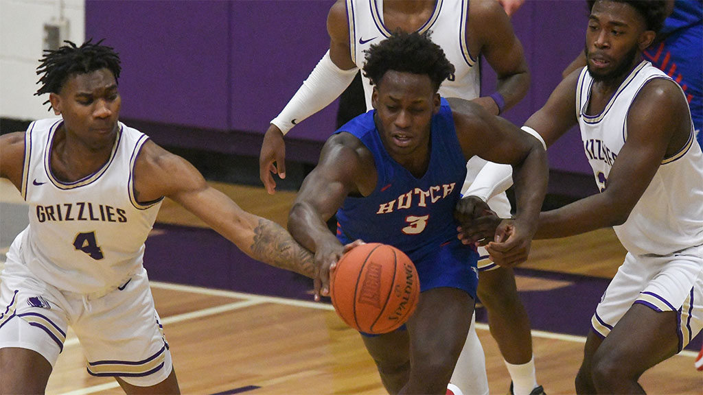 Stephan Gabriel and two Butler Grizzly players chase after a loose ball during Wednesday's Jayhawk Conference showdown in El Dorado. The Blue Dragons lost 66-65. (Photo courtesy Randy Smith)