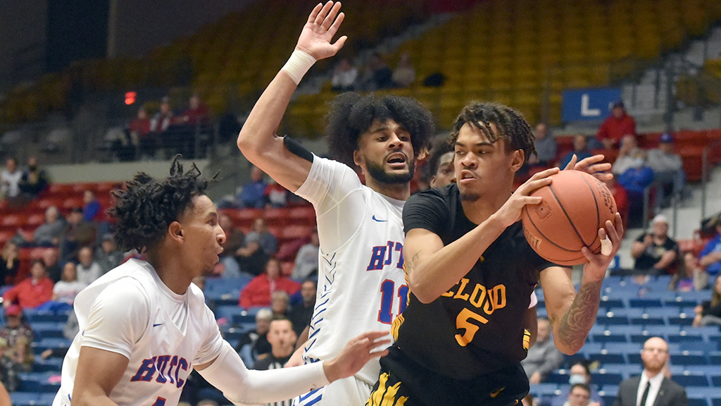 Blue Dragon defenders Jacquez Yow (11) and Cameron Robins (4) slap a double-double on Jaelen Treml, but the Thunderbirds came to the Sports Arena and earned an 87-82 win on Wednesday. (Sammi Carpenter/Blue Dragon Sports Information)