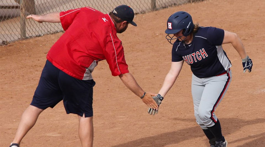 Maryssa Rollin gets a low five from third-base coach Ben Whitsitt after a three-run home run in the first inning of Game 2 on Wednesday at Fun Valley. The Blue Dragons defeated Barton 7-1 and 8-1. (Bre Rogers/Blue Dragon Sports Information)