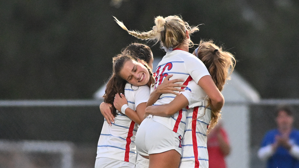 Blue Dragon teammates congratulate Katharina Marx after scoring the game's only goal with 5:02 to play in the second half of No. 11 Hutchinson's 1-0 win over No. 8 Barton on Wednesday at the Salthawk Sports Complex. (Andrew Carpenter/Blue Dragon Sports Information).