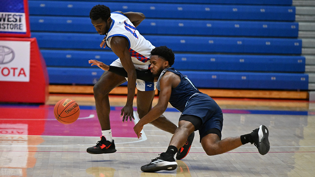 Valentino Simon battles for a loose ball near mid-court of Hutchinson's 91-82 KJCCC victory over Colby on Sunday at the Sports Arena. (Andrew Carpenter/Blue Dragon Sports Information)