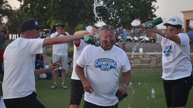 Blue Dragon players douse head coach Chris Young after the Hutchinson men's golf team won its second-straight NJCAA National Championship on Friday in Odessa, Texas (Steve Carpenter/Blue Dragon Sports Information)