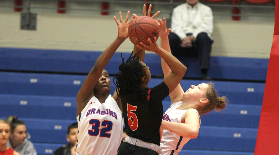 Jada Mickens and Abby Ogle defend against the shot of Allen's Jakira Wilson in the first half of Wednesday's Region VI opening-round 89-40 Blue Dragon win over the Red Devils at the Sports Arena. (Bre Rogers/Blue Dragon Sports Information).