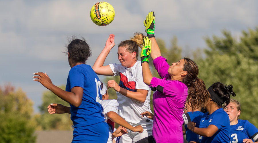 Ariel Wolff battles for a header against a pair of Pratt players in the first half of Friday's 4-0 victory by the No. 16 Blue Dragons over Pratt at the Salthawk Sports Complex. (Allie Schweizer/Blue Dragon Sports Information)